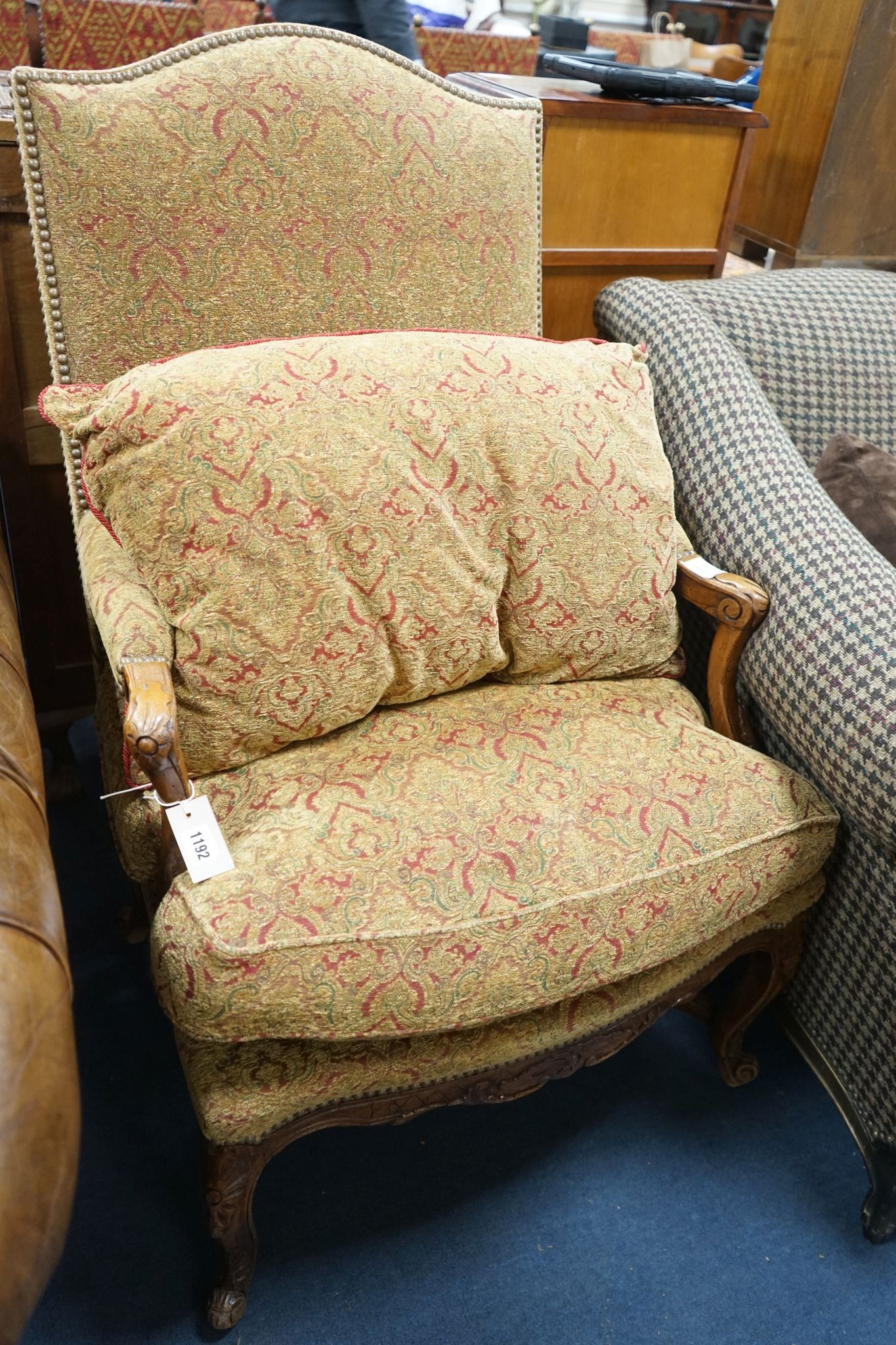 An 18th century style French walnut upholstered open armchair, width 68cm, depth 60cm, height 108cm